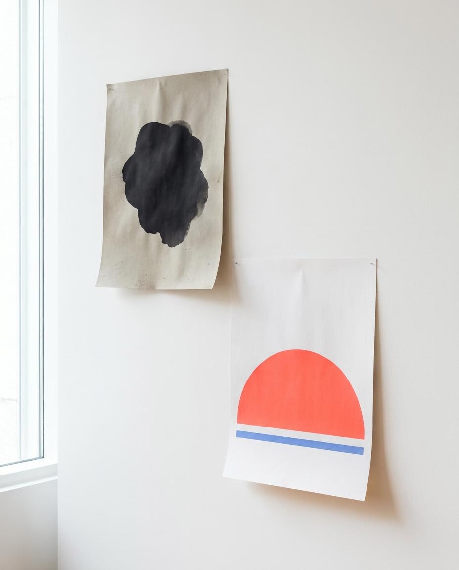 Old faded poster above a crisp new poster with a coral half circle